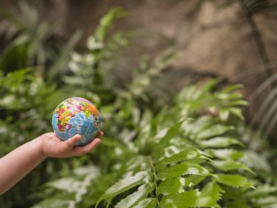 close-up-boy-s-hand-holding-inflatable-globe-ball