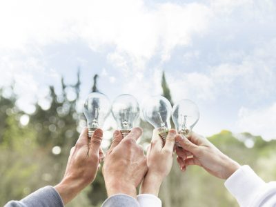 concept-people-holding-glass-bulbs-air